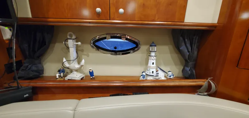 Slide: The Image of 2006 Cruisers Yachts 370 Express interior with nautical decor and porthole window. - 21