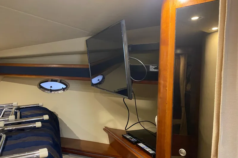Slide: The Image of Interior of 2006 Cruisers Yachts 370 Express with TV and porthole window. - 26