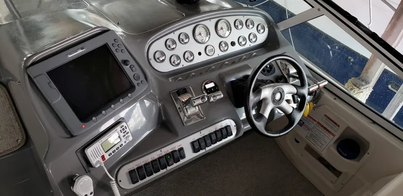 Slide: The Image of Helm of 2006 Cruisers Yachts 370 Express with steering wheel and control panel. - 4