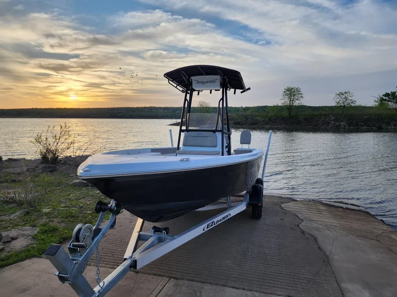 The Image of 2024 Savannah 210X boat on trailer at lakeside during sunset. - 0