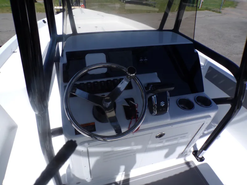 Slide: The Image of 2024 Savannah 210X boat console with steering wheel and controls. - 11