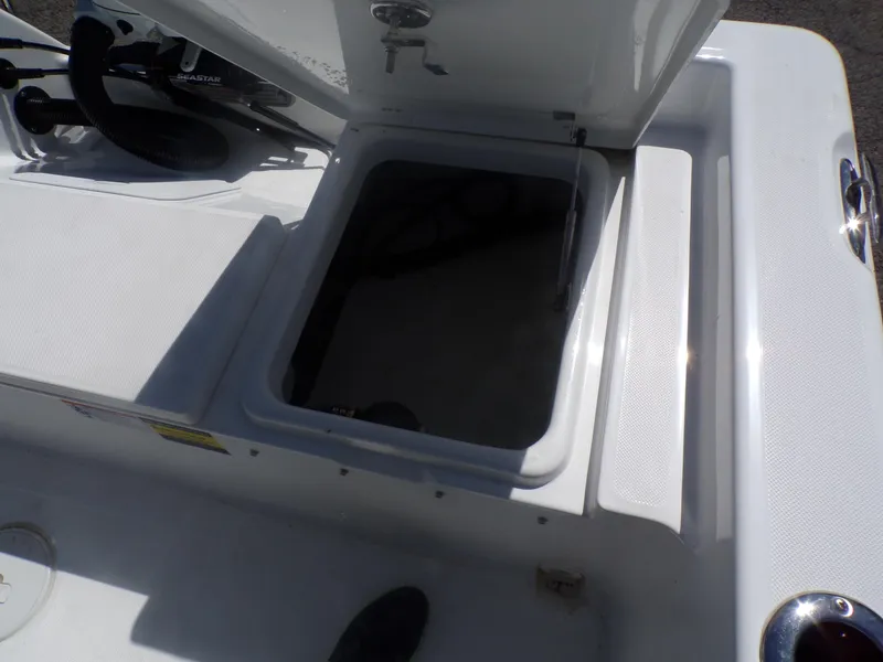 Slide: The Image of Open storage compartment on a 2024 Savannah 210X boat. - 14