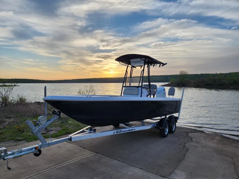 Slide: The Image of 2024 Savannah 210X boat on trailer at sunset by the lake. - 22