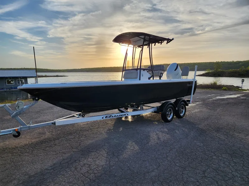 Slide: The Image of 2024 Savannah 210X boat on trailer at sunset by the lake. - 23