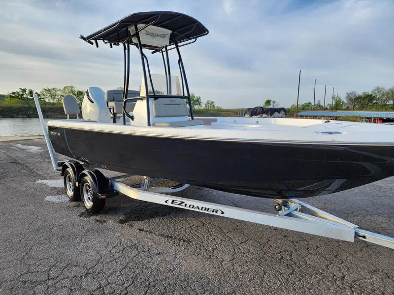 Slide: The Image of 2024 Savannah 210X boat on EZ Loader trailer at a boat launch. - 27