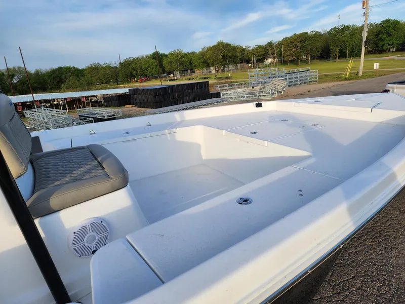 Slide: The Image of 2024 Savannah 210X boat with spacious seating and storage, docked outdoors. - 29