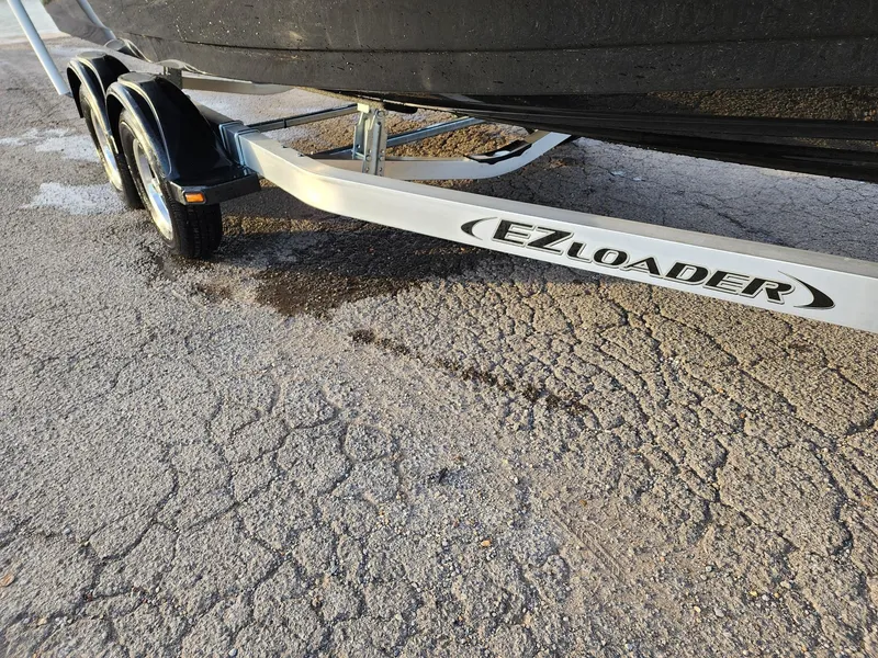 Slide: The Image of EZ Loader trailer for 2024 Savannah 210X boat on cracked pavement. - 31