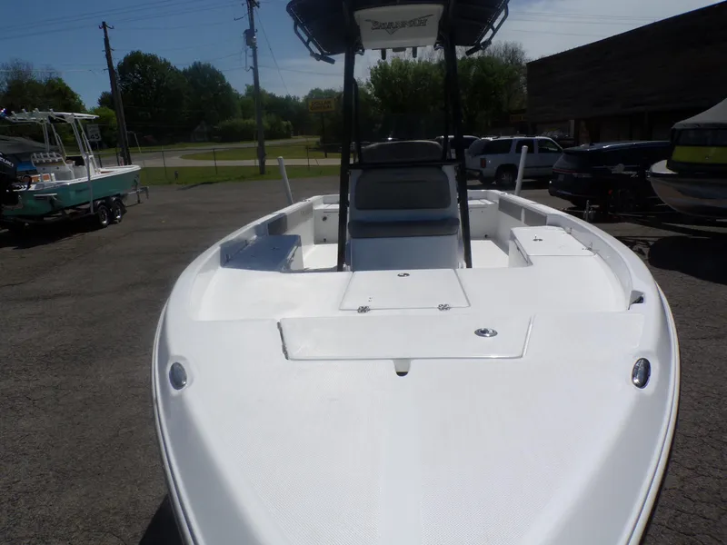 Slide: The Image of 2024 Savannah 210X boat, front view, parked outdoors. - 7