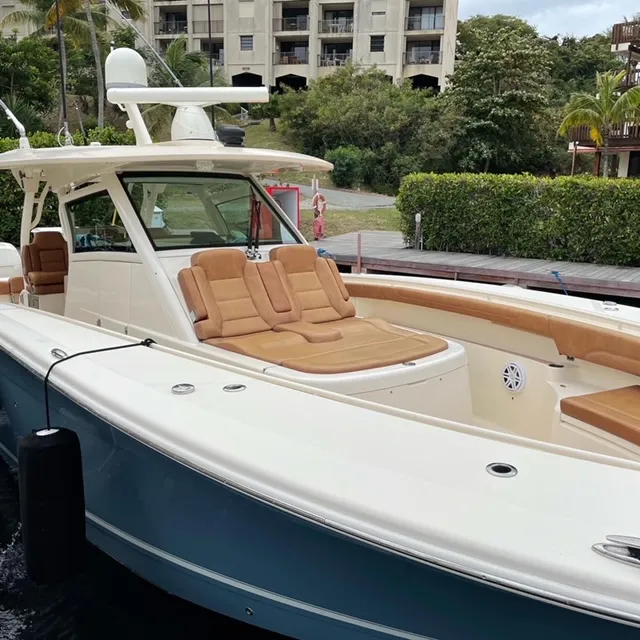 Slide: The Image of 2018 Scout 380 LXF boat docked near a resort. - 3