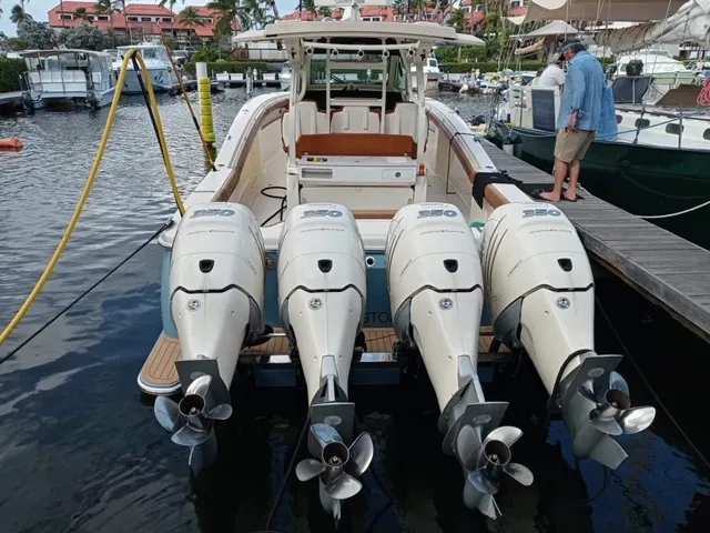 Slide: The Image of 2018 Scout 380 LXF boat with quad engines docked at marina. - 4