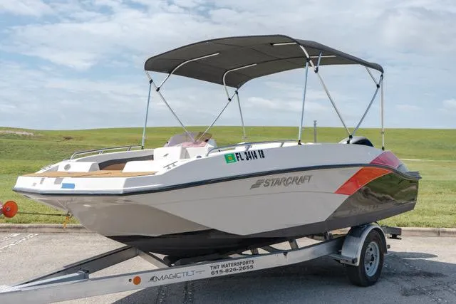 Slide: The Image of 2022 Starcraft SVX 171 OB boat on a trailer with a bimini top. - 11