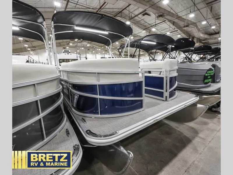Slide: The Image of 2024 Vista Fish 20 pontoon boat displayed indoors at Bretz RV & Marine showroom. - 22