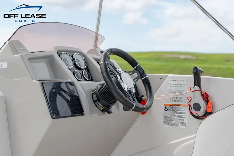 Slide: The Image of 2022 Starcraft SVX 231 OB boat dashboard with steering wheel and controls. - 10