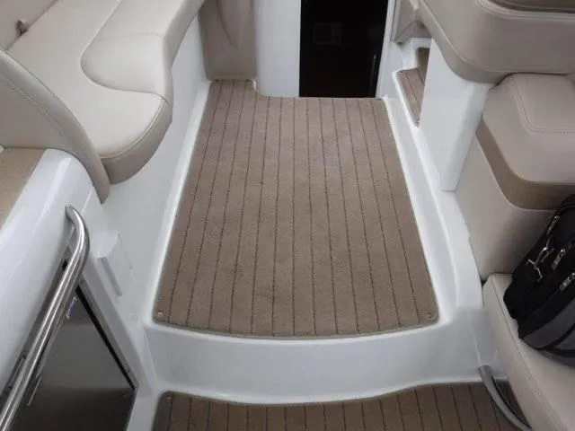 Slide: The Image of Interior of a 2012 Formula 34 Cruiser boat with beige seating and carpet. - 12