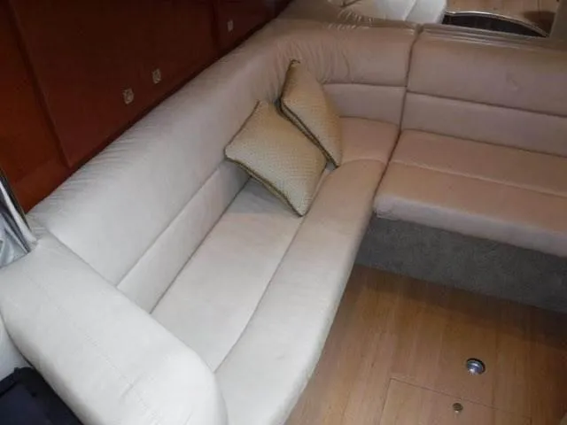 Slide: The Image of 2012 Formula 34 Cruiser interior with beige leather seating and wooden flooring. - 16