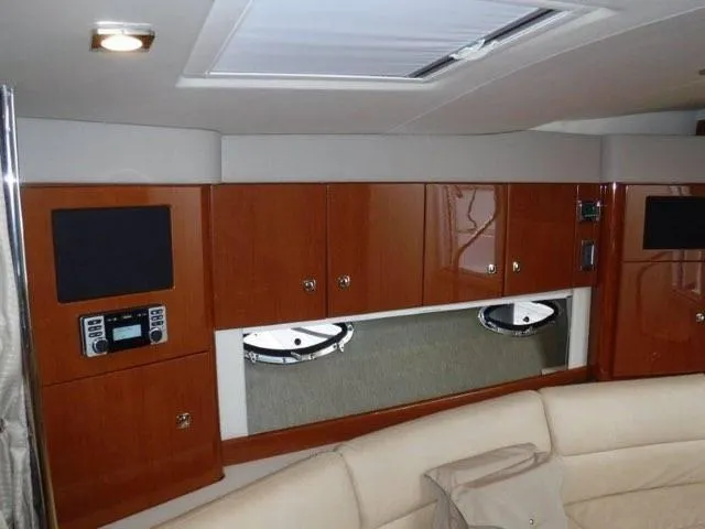 Slide: The Image of Interior of a 2012 Formula 34 Cruiser with wooden cabinets and beige seating. - 18