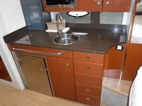 Slide: The Image of 2012 Formula 34 Cruiser kitchen area with sink, fridge, and storage drawers. - 19