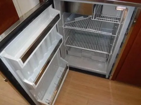 Slide: The Image of Open refrigerator in 2012 Formula 34 Cruiser boat with empty shelves. - 25