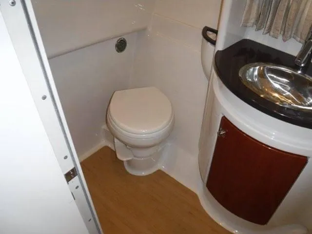 Slide: The Image of 2012 Formula 34 Cruiser bathroom with toilet and sink. - 26