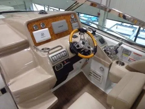 Slide: The Image of 2012 Formula 34 Cruiser helm with modern controls and wood accents. - 4