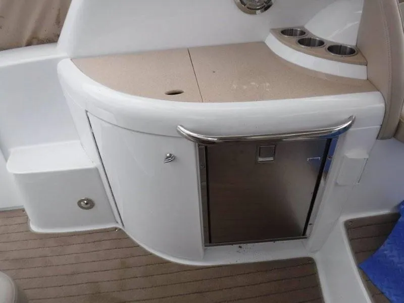 Slide: The Image of 2012 Formula 34 Cruiser boat interior with mini fridge and storage cabinet. - 9