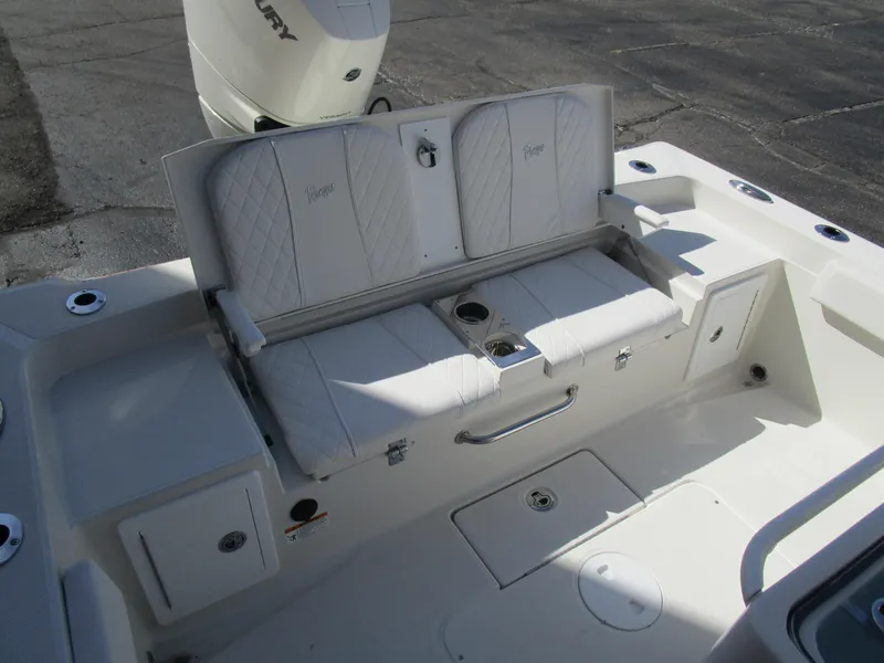 Slide: The Image of 2024 Ranger 2660 Bay boat with white cushioned seating and storage compartments. - 10