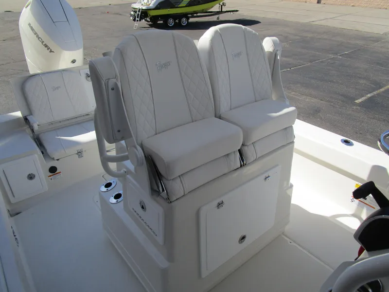 Slide: The Image of 2024 Ranger 2660 Bay boat with dual cushioned seats and storage compartment. - 16