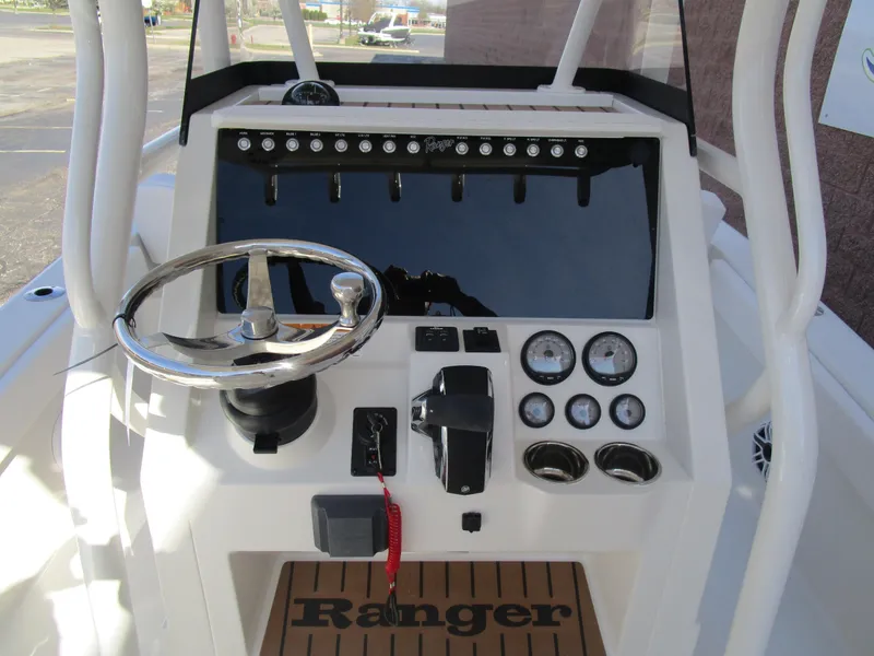 Slide: The Image of 2024 Ranger 2660 Bay boat console with steering wheel and gauges. - 17