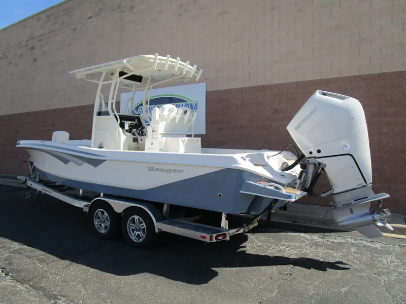 Slide: The Image of 2024 Ranger 2660 Bay boat on a trailer, parked outdoors. - 2
