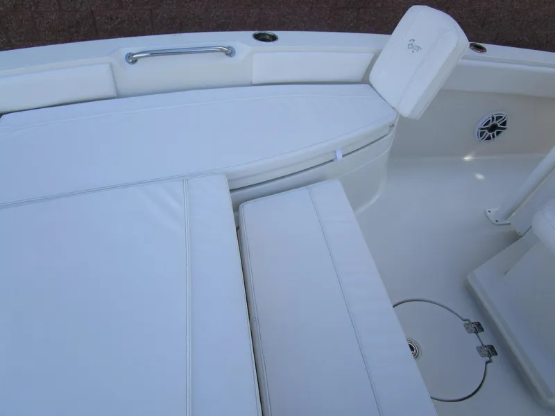 Slide: The Image of 2024 Ranger 2660 Bay boat interior with white cushioned seating and storage compartments. - 25