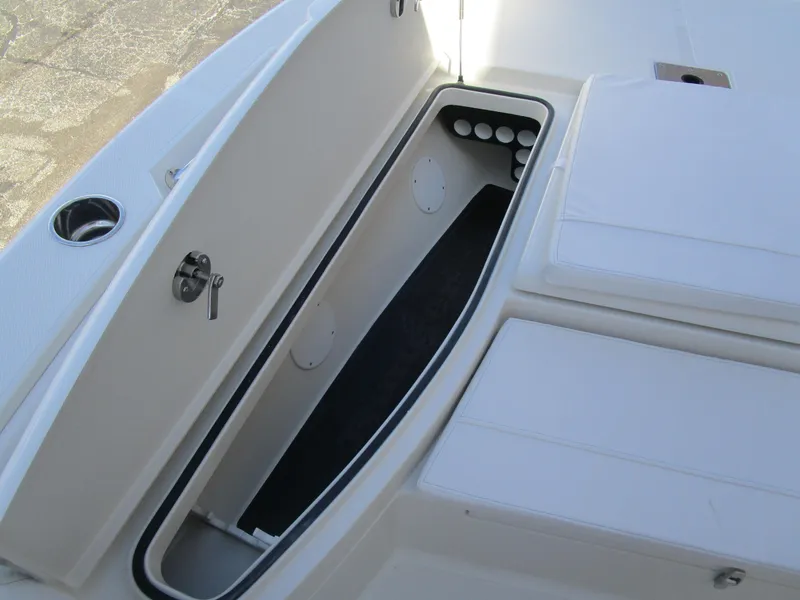 Slide: The Image of 2024 Ranger 2660 Bay boat storage compartment with cushioned seating. - 27