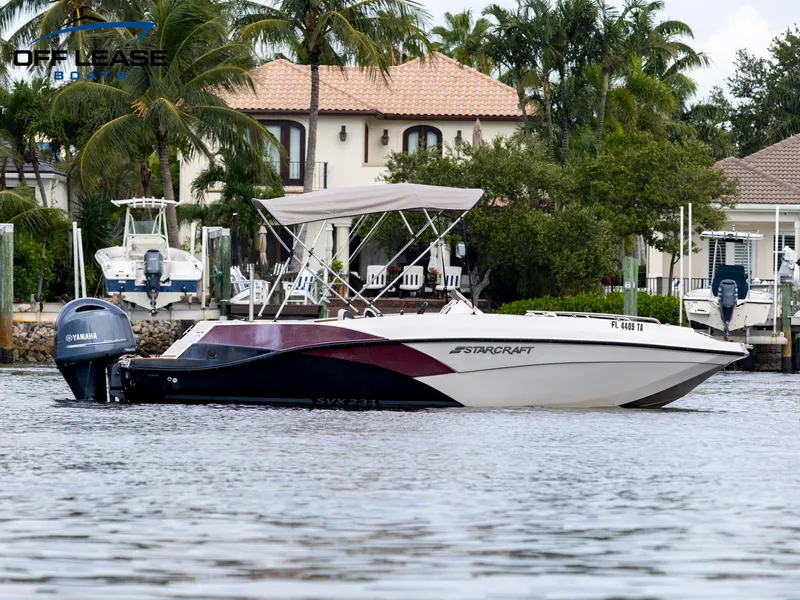 Slide: The Image of 2021 Starcraft SVX 231 OB boat on water near waterfront homes. - 1