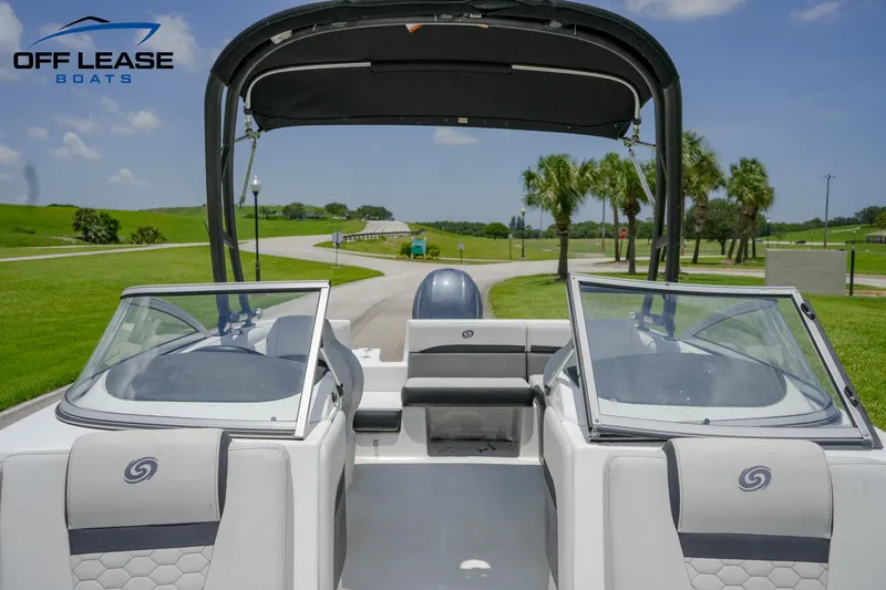 Slide: The Image of 2020 Hurricane 217 SD boat with dual consoles and bimini top on a sunny day. - 12