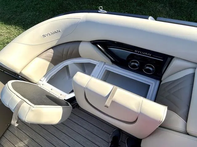 Slide: The Image of 2024 Sylvan M3 DLZ boat interior with storage compartments and cushioned seating. - 12