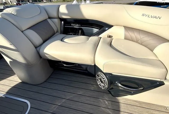 Slide: The Image of 2024 Sylvan M3 DLZ boat interior with beige leather seating and speaker system. - 13