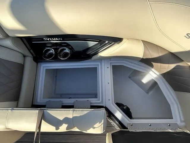 Slide: The Image of 2024 Sylvan M3 DLZ boat interior with storage compartment and beige seating. - 14