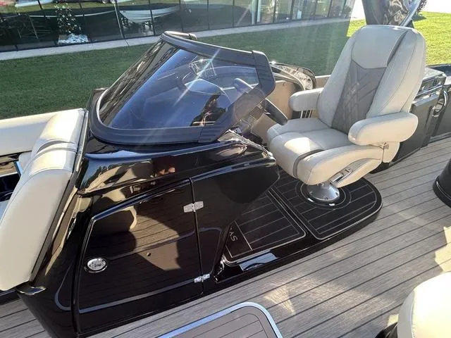 Slide: The Image of 2024 Sylvan M3 DLZ boat cockpit with captain's chair and sleek dashboard. - 18