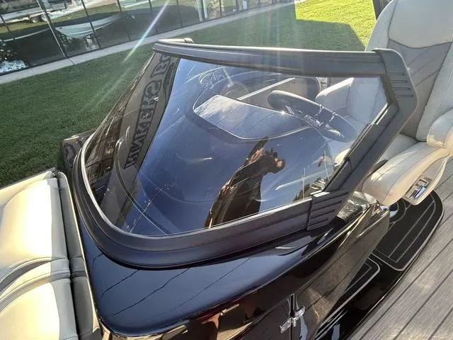 Slide: The Image of 2024 Sylvan M3 DLZ boat windshield and seating area. - 19