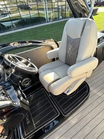Slide: The Image of Captain's chair of 2024 Sylvan M3 DLZ boat with steering wheel and dashboard. - 20