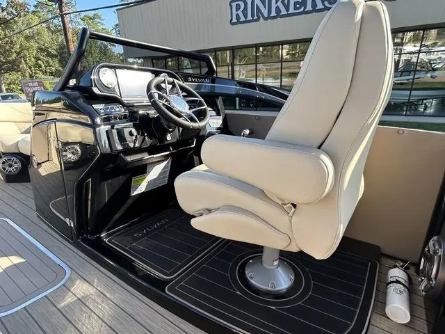 Slide: The Image of 2024 Sylvan M3 DLZ boat cockpit with captain's chair and steering console. - 23