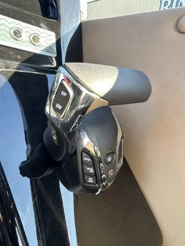 Slide: The Image of 2024 Sylvan M3 DLZ boat control lever with buttons for various functions. - 25