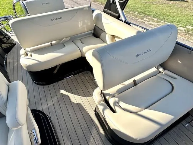 Slide: The Image of 2024 Sylvan M3 DLZ boat interior with beige leather seating and wooden flooring. - 27