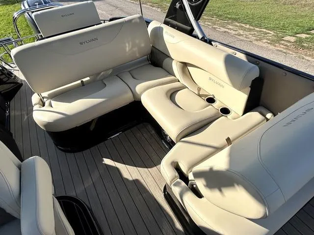 Slide: The Image of 2024 Sylvan M3 DLZ boat interior with beige leather seating and cup holders. - 28