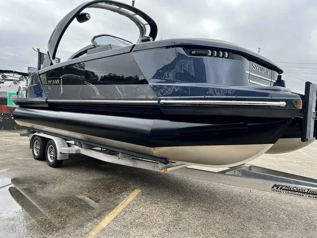 Slide: The Image of 2024 Sylvan M3 DLZ pontoon boat on a trailer, side view. - 3