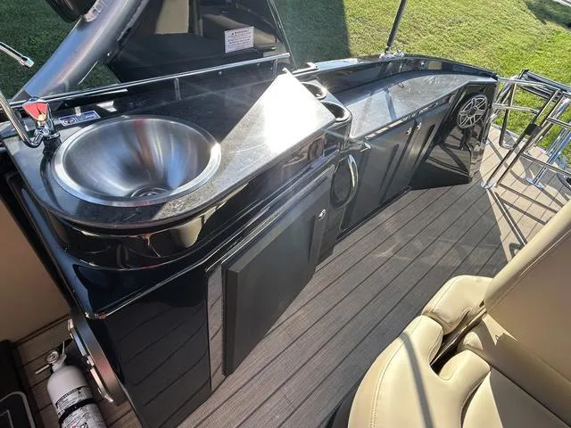 Slide: The Image of 2024 Sylvan M3 DLZ boat interior with sink and counter space. - 30