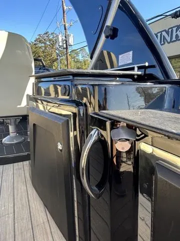 Slide: The Image of 2024 Sylvan M3 DLZ boat interior with sleek black cabinetry and modern design. - 32