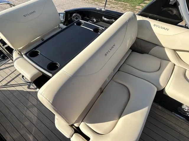 Slide: The Image of 2024 Sylvan M3 DLZ boat with luxurious beige seating and cup holders. - 35