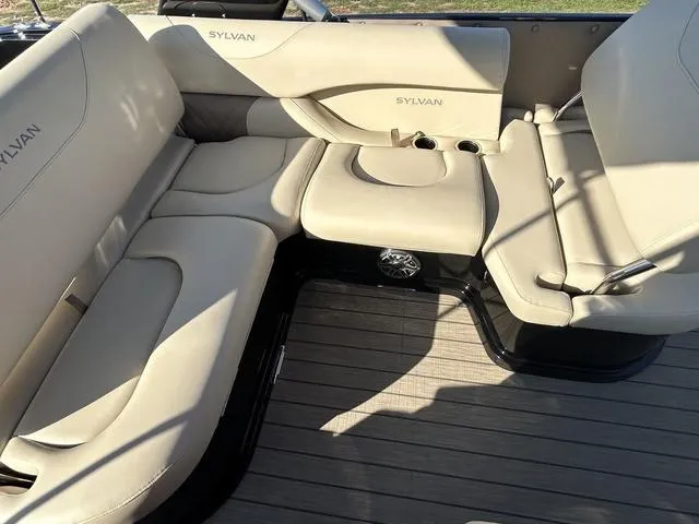 Slide: The Image of 2024 Sylvan M3 DLZ boat interior with beige seating and cup holders. - 36