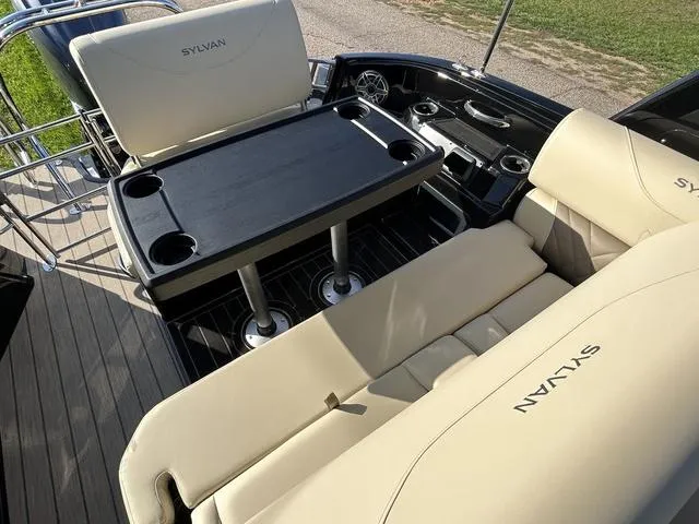 Slide: The Image of 2024 Sylvan M3 DLZ boat interior with beige seating and black table. - 39