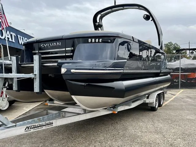 Slide: The Image of 2024 Sylvan M3 DLZ pontoon boat on a trailer at a dealership. - 4